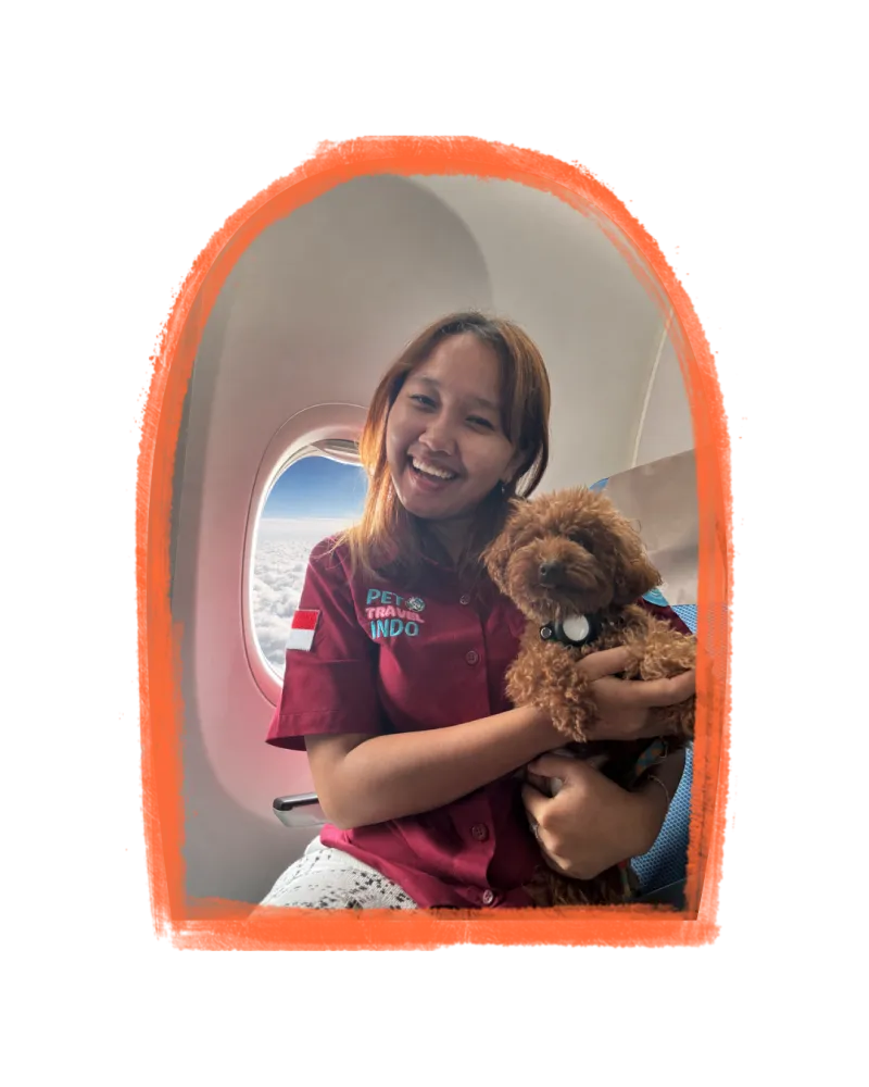 Vina Atika, founder of Pet Travel Indo, with a small dog in an airplane cabin